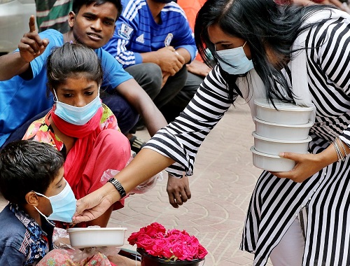 A Jubo League member distributes cooked food among some low-income people in front of the Central Shaheed Minar in the capital ,marking the National Mourning Day. The Awami League and its associated bodies, including the Jubo League, gave away food to the poor, distressed, and orphans across the country on the occasion.Photo was Published August 16.2020